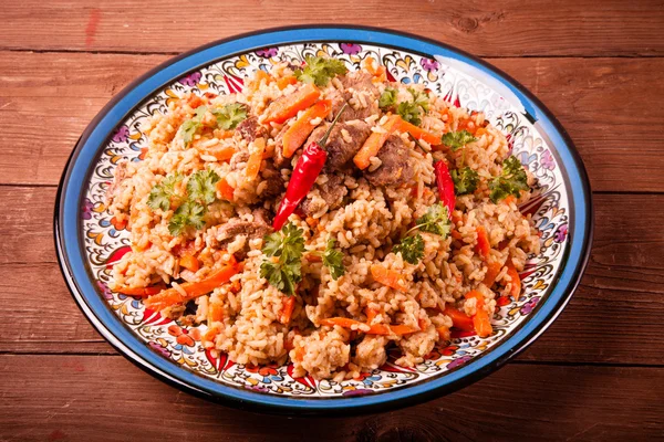 Delicious pilaf on a turkish plate on old wooden table. Rustic s — Stock Photo, Image