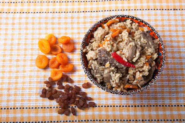 Hot delicious pilaf on a turkish dish on yellow tablecloth. With — Stock Photo, Image