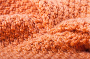 Turuncu örgü yün kazak kıvrımları. Arka plan