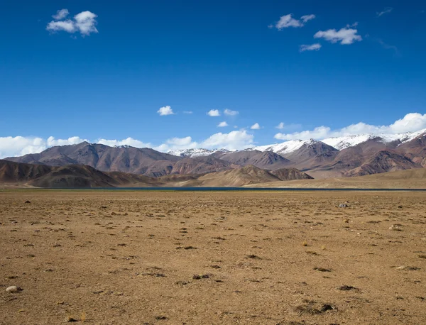 Rocky mountains and scorched valley on a background of blue sky — Stock Photo, Image