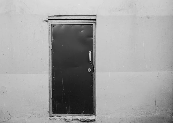 Covered with leather door with white metal handle and plastered — Stock Photo, Image