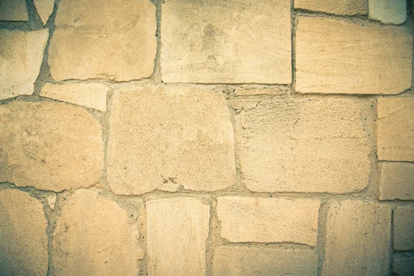 Beige wall of natural stones. Background. Toned — Stock Photo, Image