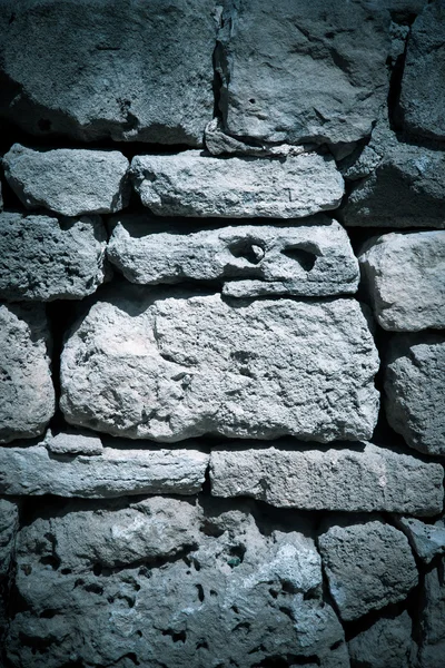 Wall made of natural stones. Background. Toned — Stock Photo, Image