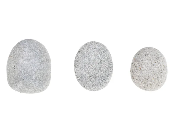 Üç gri yuvarlak taşlar beyaz bir arka plan üzerinde izole — Stok fotoğraf