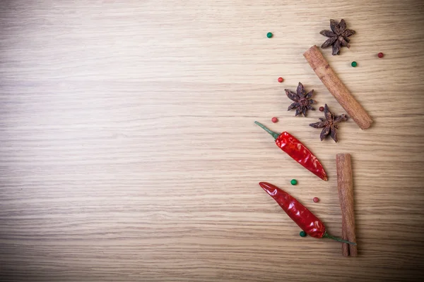 Cinnamon, cardamom, red chili and colorful bell pepper on a ligh — Stock Photo, Image