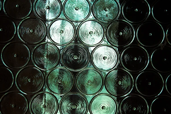 Wall of glass bottles with somthing metall behind it. Selective — Stock Photo, Image