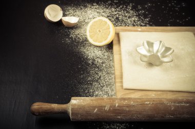 Set for home baking on a black background with flour. Rolling pi clipart
