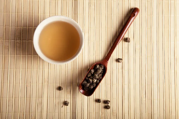 Green tea on a light bamboo mat. Toned — Stock Photo, Image