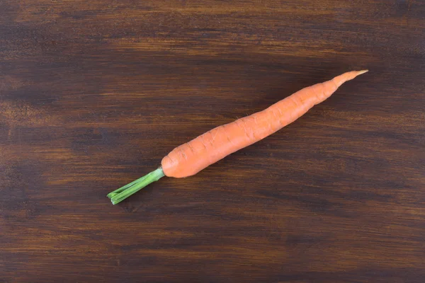 Carrot on brown cutting board — ストック写真