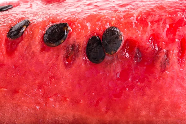 Sladký šťavnatý meloun s černými semeny. pozadí. Mělký dep — Stock fotografie