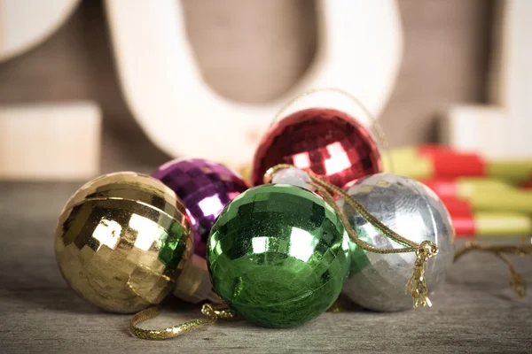 Cristmas colored balls on old wooden board with blured backgroun — Stock Photo, Image