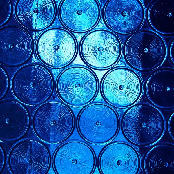 Wall of glass with pattern like bottles bottom with somthing met — Stock Photo, Image