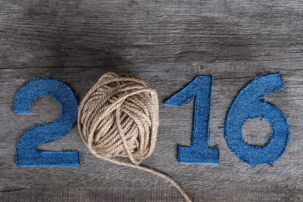 Denim digits 2016 on a gray wooden background. Instead of zero i — Stock Photo, Image