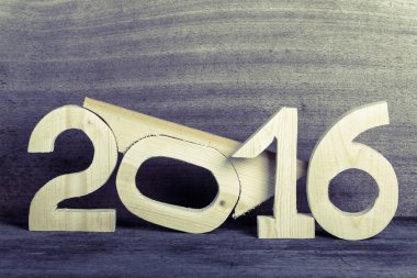 Light wooden figures 2016 on gray wooden background in retro vin