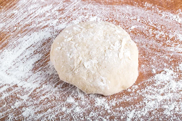 Laghman dough on an old wooden worn board with flour. Toned — Stock Photo, Image