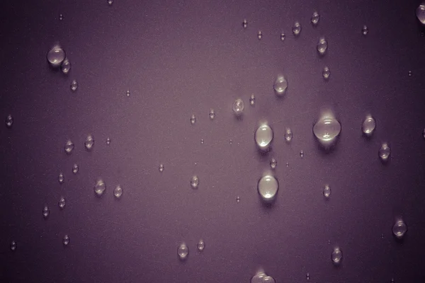 Drops of water on a color background. Purple. Selective focus. T — Stock Photo, Image