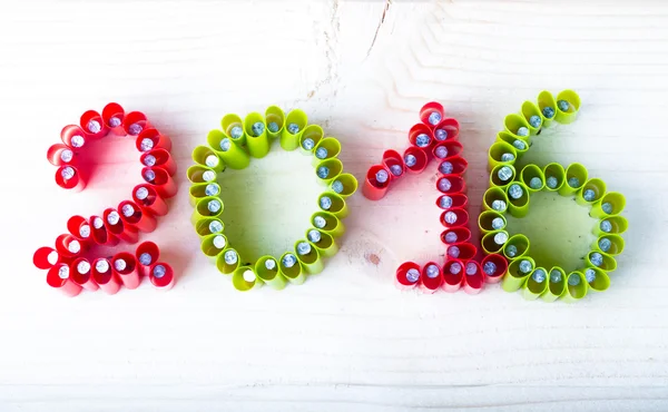 The number 2016 of nails with parts of straws on a light wooden — Stock Photo, Image