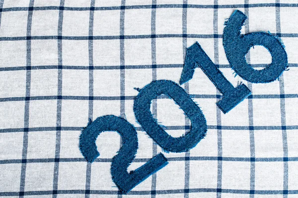 Denim digits 2016 on a checkered cloth background. Toned — Stock Photo, Image