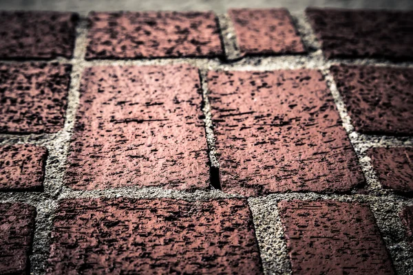 Fragment of red brick wall for background. Toned — Stock Photo, Image