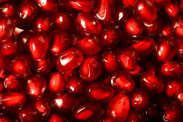 Juicy ripe seeds of pomegranate like natural background. Toned — Stock Photo, Image