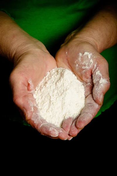 Flour in the womans hand. Selective focus. Toned — Stock Photo, Image