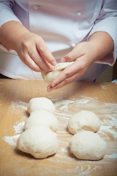 Woman's hands knead dough. Selective focus. Toned — Stock Photo, Image