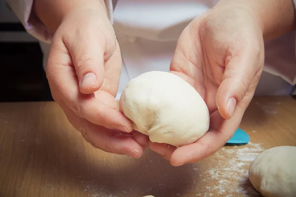 Woman's hands knead dough. Selective focus. Toned — Stock Photo, Image