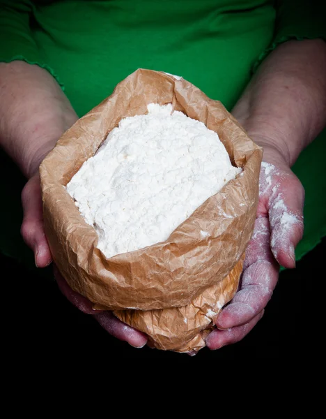 Flour in the womans hand. Selective focus. Toned — Stock Photo, Image