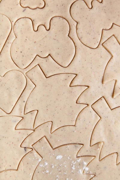 Dough for gingerbread cookie and cookie cutted in different shap — Stockfoto