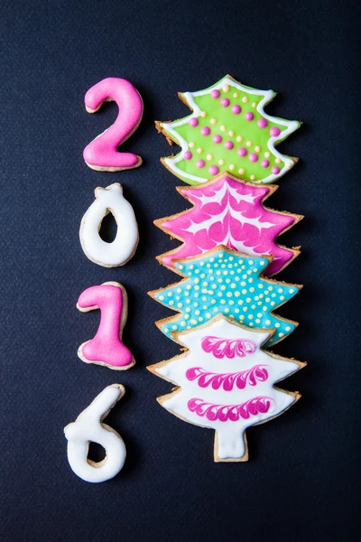 Gingerbread homemade cookies with icing on a black table or boar — Stock Photo, Image