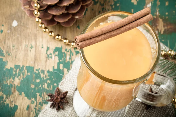 Glass of sea buckthorn beverage (kissel) on a napkin on old wood — Stock Photo, Image