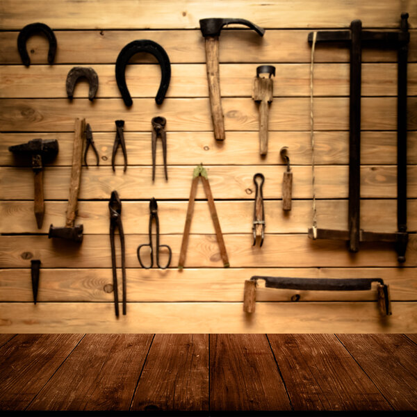 Light wooden wall with different vintage carpentry tools. Backgr