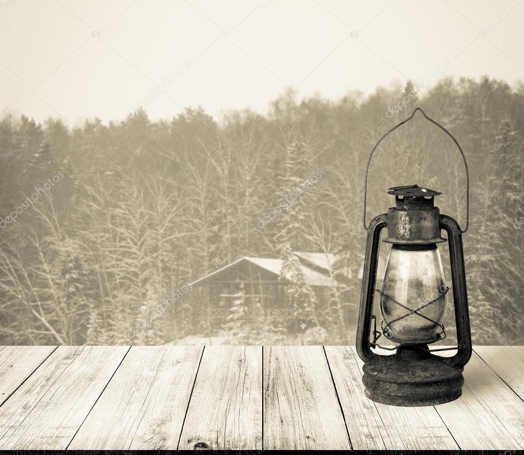 View on house in snowy winter forest from dark wooden gangway, t