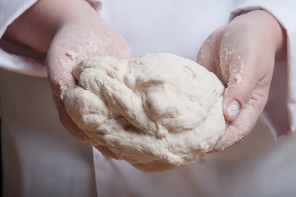 Raw dough in a chef hands — Stock Photo, Image