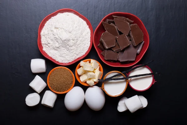 Ingredients for sweet pastry on a black wooden background — Stock Photo, Image