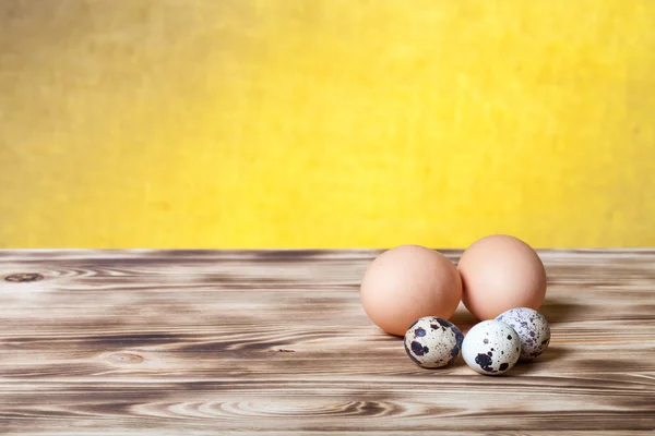 Eggs on new wooden board and burlap background. Selective focus — Stock Photo, Image