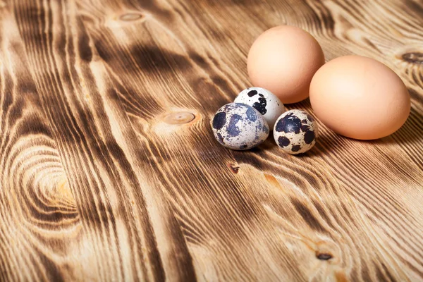 Eggs on new wooden board. Selective focus — Stock Photo, Image