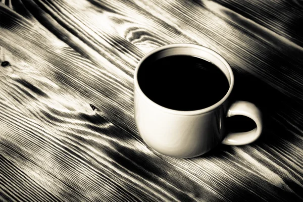 Coffee in cup on wooden table for background. Toned — Stock Photo, Image