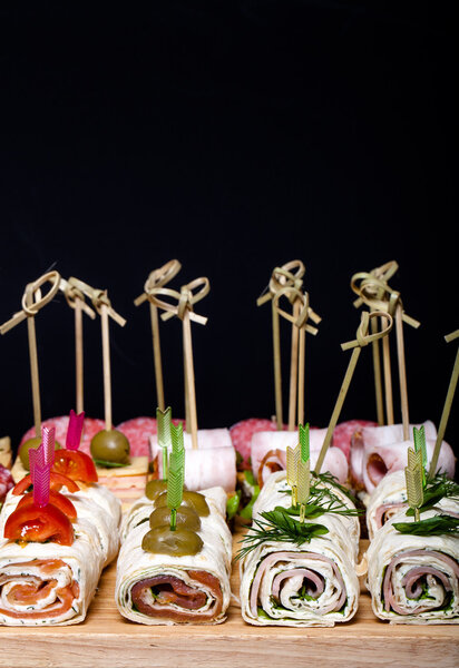 Different kinds of snacks canape on skewers. Shallow depth of fi