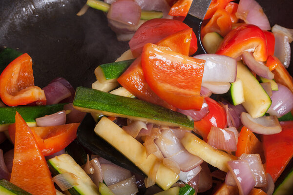 Set of vegetables fried in a pan. Selective focus