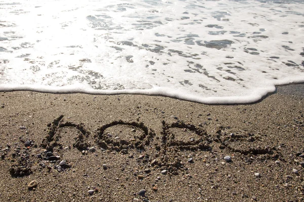 Ola e inscripción "ESPERANZA" en la costa de guijarros del mar. Selectiv — Foto de Stock
