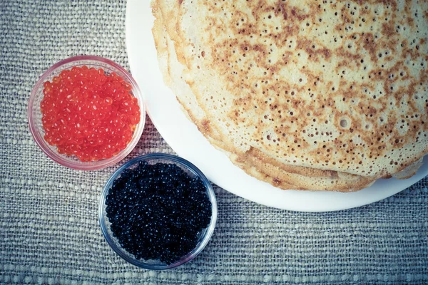 Russian pancakes - blini with red and black caviar. Toned — Stock Photo, Image