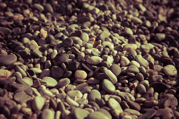 Background of natural pebble on a sea coast. Selective focus. To — Stock Photo, Image