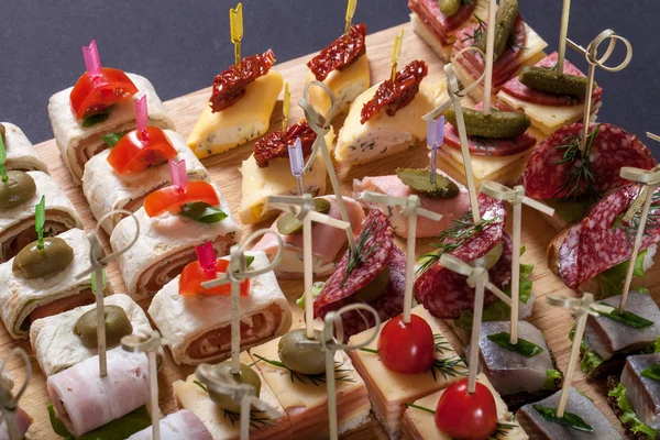 Diferentes tipos de bocadillos canapé en pinchos. Enfoque selectivo — Foto de Stock