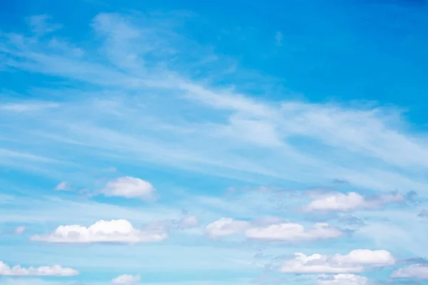 Gentle blue sky with white beautiful cirrus clouds, natural heavenly abstract background with good weather.