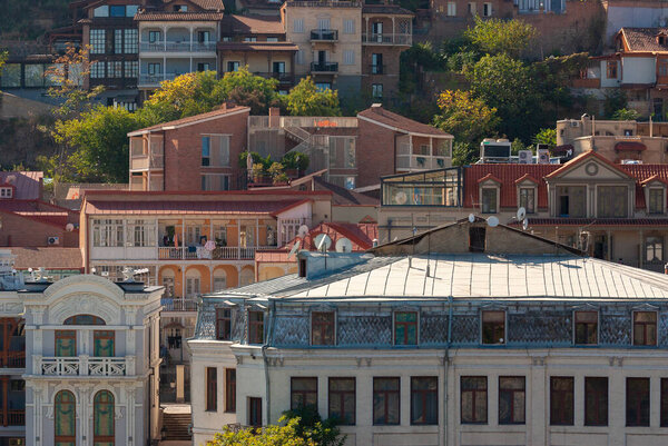 Georgia, Tbilisi - October 23, 2020: Houses with balconies in the historic district of Tbilisi. Georgia. Evening View. Beautiful Old town at sunset.