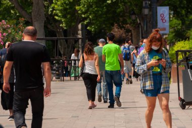 Georgia, Tbilisi - May 23, 2021: Crowd of anonymous people walking on busy city street.