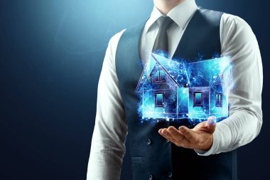 İş adamının elinde evin mavi bir hologramı var. Ev kredisi, ipotek, konut için banka kredisi, yatırım. Karışık ortam.