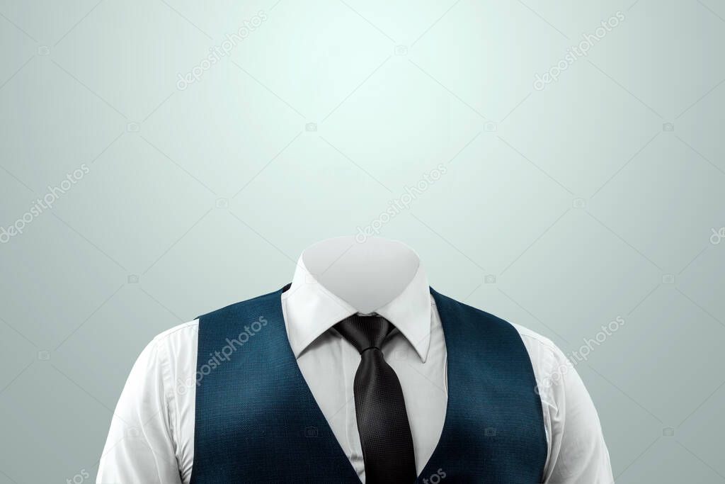 Businessman in a white shirt, vest and headless tie on a light background. Copy space