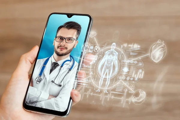 Portrait of a man, a doctor on a smartphone screen, a video conference, an appointment with a doctor online. Hologram graphics medical indicators. Medical technology concept, the future of medicine